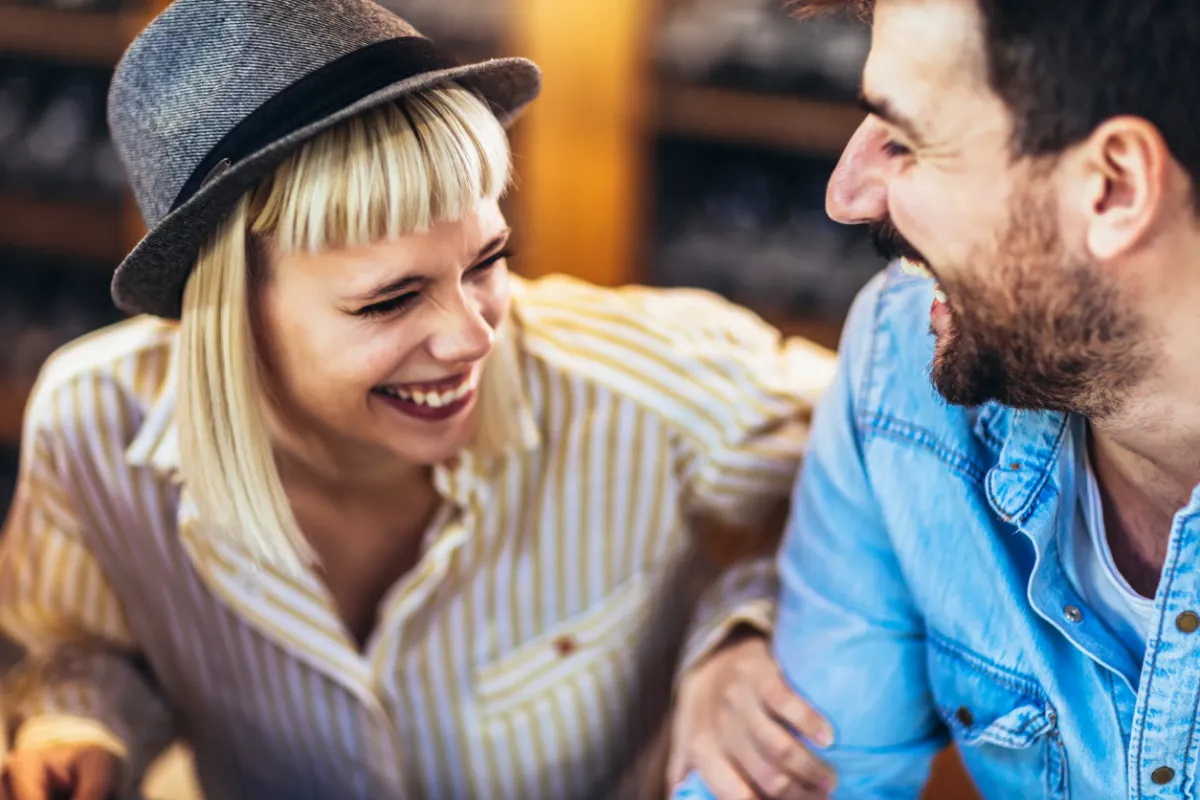 Happy girl and guy laughing