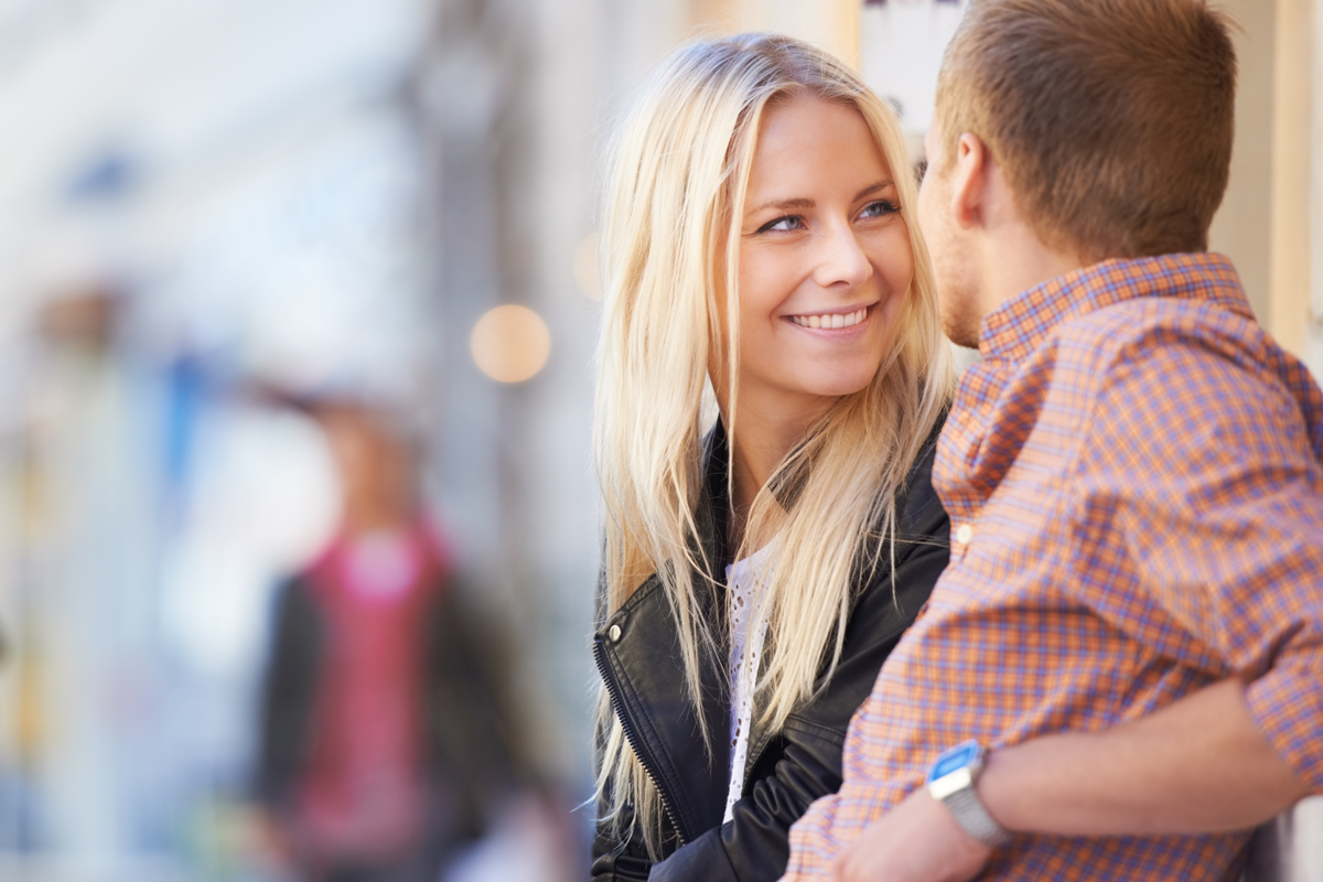 Pretty blonde woman smiling at her date